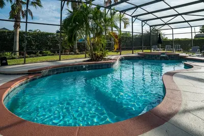 a large pool with blue water in a resort at Luxury Villa! Fun in the Sun! Formosa Gardens in Orlando