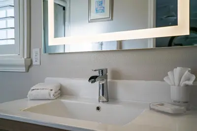 a sink in a bathroom with a mirror at Luxury Villa! Fun in the Sun! Formosa Gardens in Orlando