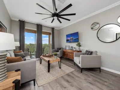 a living room with a ceiling fan and a table at Mickey's Hideaway Windsor Hills Resort in Orlando