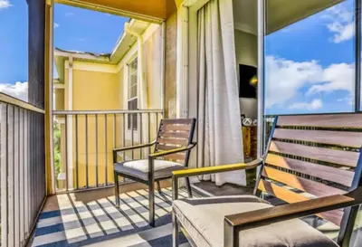 a balcony with two chairs and a table at Mickey's Hideaway Windsor Hills Resort in Orlando