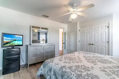 a bedroom with a bed and a flat screen tv at 4552 Bella Vida 2 in Kissimmee