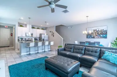 a living room with a couch and a kitchen at 5134 Compass Bay in Kissimmee