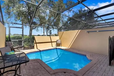 a large swimming pool with a pergola at Minutes to Disney, Free Water Park & Private Pool in Orlando