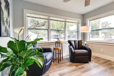 a living room with two chairs and a plant at Dtwn Winter Garden Home 12 Mi to Disney! in Orlando
