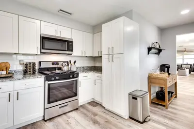 a kitchen with white cabinets and a stove at Dtwn Winter Garden Home 12 Mi to Disney! in Orlando
