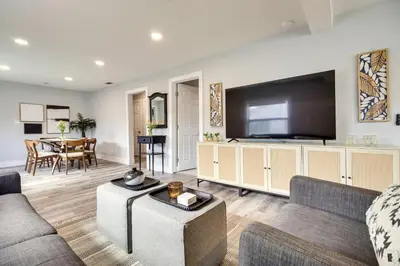 a living room with a large flat screen tv at Dtwn Winter Garden Home 12 Mi to Disney! in Orlando