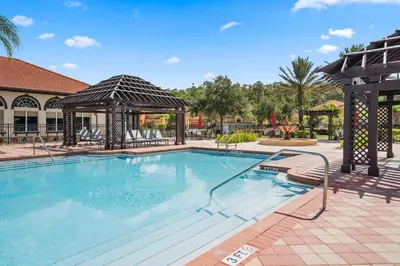 a large swimming pool with a gazebo at Modern 6BR Home - Pool BBQ Hot Tub - Near Disney in Kissimmee