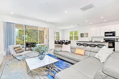 a living room with a couch and a table at Modern 6BR Home - Pool BBQ Hot Tub - Near Disney in Kissimmee