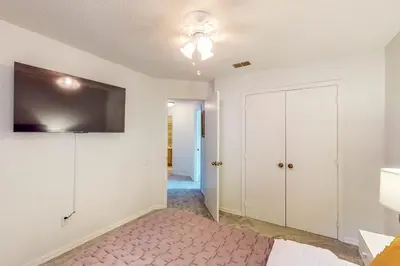 a bedroom with a bed and a tv on the wall at Families with Pets! Home Near Orlando Theme Parks in Orlando