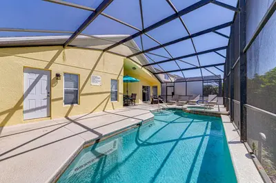 an indoor swimming pool with a glass ceiling at #463-Fabulous 4 bed villa with south facing private pool and spa overlooking water in Kissimmee