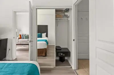 a bedroom with a mirror and a bed and a room with a bed sqor at 1BR FREE Shuttle to Disney Parks HS305 in Orlando