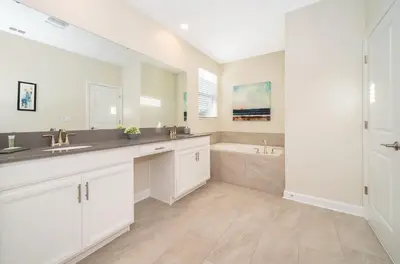 a white bathroom with two sinks and a tub at Fabulous Villas 5 minutes away from Disney! in Kissimmee