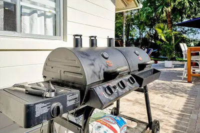 a grill sitting on a sidewalk next to a house at Private Villa/Outdoor Oasis in Kissimmee