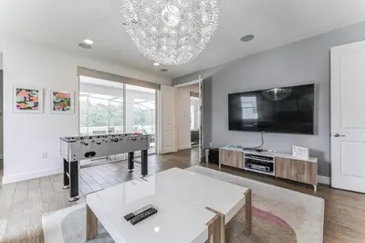 a living room with a pool table and a flat screen tv at 65 Home At Sonoma Resort, Private Pool, And Much More!! in Kissimmee
