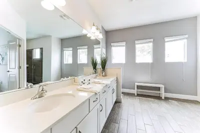 a bathroom with two sinks and a large mirror at 65 Home At Sonoma Resort, Private Pool, And Much More!! in Kissimmee