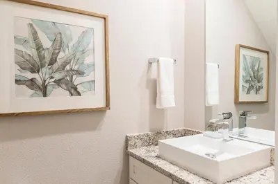a bathroom with a white sink and a mirror at Gorgeous New 4 Beds DREAM Villa 5 min to Disney in Orlando