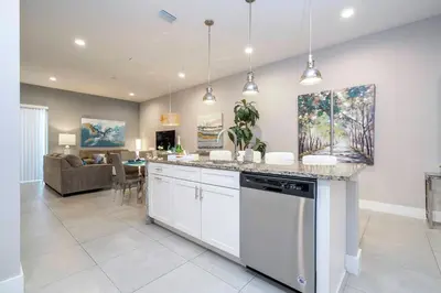 a kitchen and living room with a counter top at Gorgeous NEW 4 Beds Dream Villa 5 min to Disney in Orlando