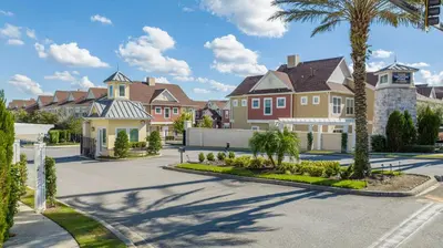 a row of houses in a residential neighborhood with palm trees at Gorgeous NEW 4 Beds Dream Villa 5 min to Disney in Orlando