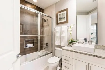 a bathroom with a toilet and a shower and a sink at 5 Suites DREAM House 5 min to Disney in Orlando