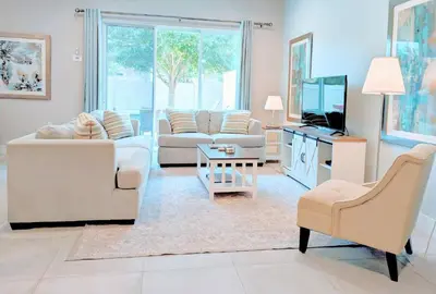 a living room with two couches and a tv at 5 Suites DREAM House 5 min to Disney in Orlando