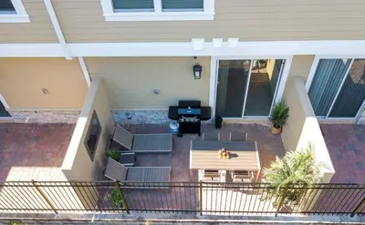 an aerial view of a patio with chairs and a table at Dreamscape NEW 4 Suites Villa 5 min to Disney in Orlando