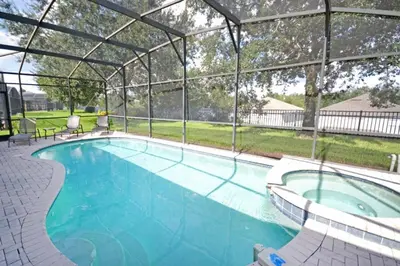 a large swimming pool with a pergola at Under The Sea Villa villa in Orlando