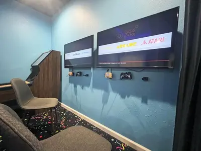 a waiting room with a chair and a large screen at Under The Sea Villa villa in Orlando