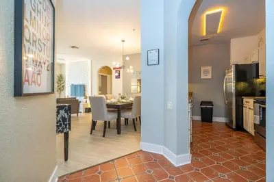 a kitchen and dining room with a table and a dining room at Incredible Condo - 5 Min to Disney Windsor Hills in Orlando