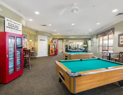 a billiard room with two pool tables and a bar at Incredible Condo - 5 Min to Disney Windsor Hills in Orlando