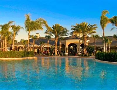 a resort with palm trees and a swimming pool at Charming 3BR Townhome Private Pool Walk to Clubhouse 9 Min Disney in Orlando