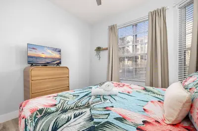 a bedroom with a bed and a dresser and a window at Windsor Hills Dream - 3BR - 2 miles from Disney in Orlando