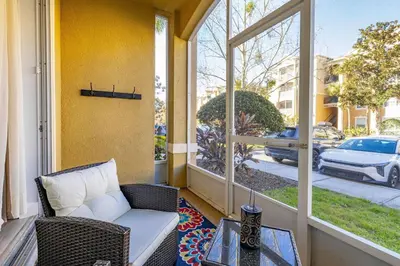 a porch with a couch and a table and a window at Windsor Hills Dream - 3BR - 2 miles from Disney in Orlando
