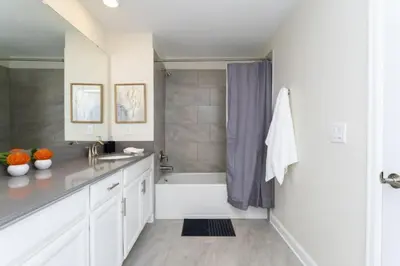 a white bathroom with a tub and a sink at Amazing Villa 5BR Heated Pool Themed Rooms - 5 miles Disney in Kissimmee
