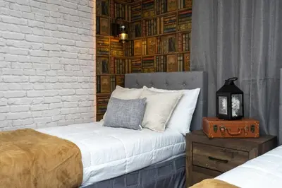 a bedroom with two beds and a brick wall at Amazing Villa 5BR Heated Pool Themed Rooms - 5 miles Disney in Kissimmee