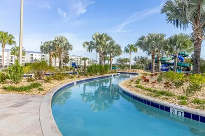 a swimming pool with palm trees and a water park at Lake View - 10 min to Disney Storey Lake Resort in Kissimmee