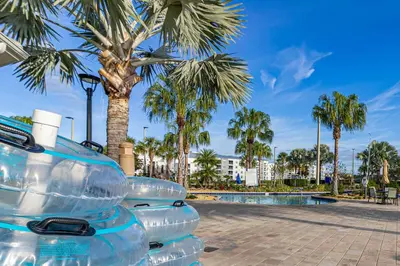 a stack of empty water bottles sitting next to a palm tree at Lake View - 10 min to Disney Storey Lake Resort in Kissimmee
