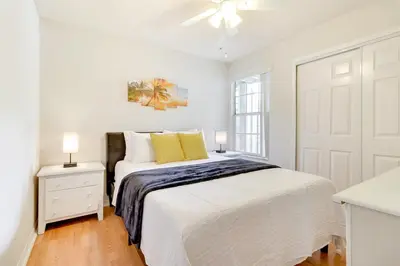 a white bedroom with a bed and a window at Condo with Pool Access and Patio 8 Mi to Disney! in Kissimmee