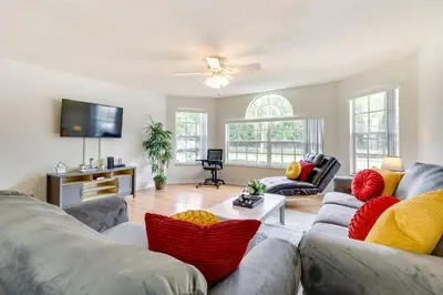 a living room with two couches and a flat screen tv at Condo with Pool Access and Patio 8 Mi to Disney! in Kissimmee