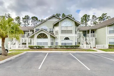 a house with a parking lot in front of it at Condo with Pool Access and Patio 8 Mi to Disney! in Kissimmee