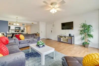 a living room with a couch and a table at Condo with Pool Access and Patio 8 Mi to Disney! in Kissimmee