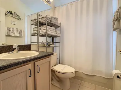 a bathroom with a sink and a toilet and a shower at Magic Orlando Villa, You are in Disney in Kissimmee