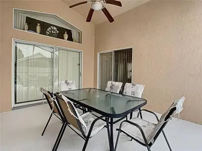 a dining room table with chairs and a ceiling fan at Magic Orlando Villa, You are in Disney in Kissimmee