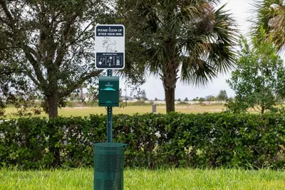 a street sign on a pole in the grass at Hampton Inn Orlando Southeast Nona in Orlando
