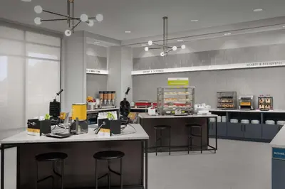 a store with two counters and stools in a room at Hampton Inn Orlando Southeast Nona in Orlando