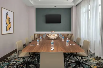 a conference room with a large wooden table and chairs at Hampton Inn Orlando Southeast Nona in Orlando